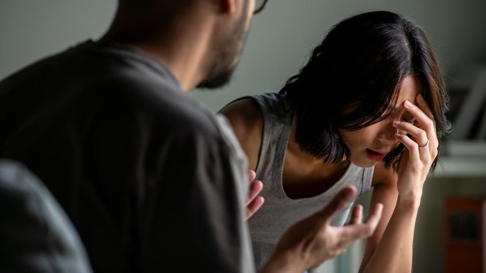 Young Asian married couple after a fight, Angry couple ignoring each other, relationship troubles.