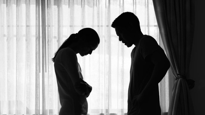 Young Asian married couple after a fight, Angry couple ignoring each other, relationship troubles.