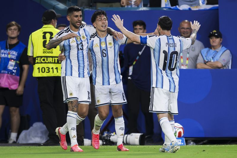 HARD ROCK STADIUM, MIAMI GARDENS, FLORIDA, UNITED STATES - 2026/07/03: Lisandro Martinez (C) of Argentina celebrates with Cristian Romero (L) and Lionel Messi (R) of Argentina after scoring a goal during the FIFA World Cup 2026 round of 32 football match between Argentina and Cabo Verde. Argentina won 3-2 over Cabo Verde after extra time. (Photo by Nicolò Campo/LightRocket via Getty Images)