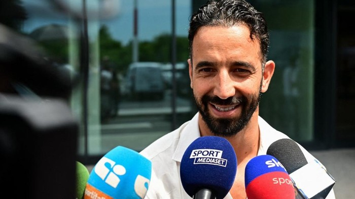 Italian football club AC Milans newly recruited Portuguese coach Ruben Amorim talks to the press as he leaves Linate Airport after his arrivhal in Milan on July 6, 2026. (Photo by Piero CRUCIATTI / AFP)
