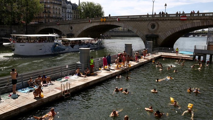 A lifeguard watches as people swim in the River Seine at the Bras Marie public swimming site, open to swimmers for the second year in the capital's historic waterway, in Paris, France, July 5, 2026. REUTERS/Tom Nicholson