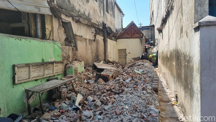 Rumah kontrakan di Jalan Kalisari Sayangan I, Kecamatan Genteng, Surabaya yang bagian depannya sudah dirobohkan.