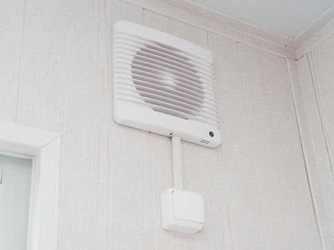 The photo of the fan on a white wall for air circulation