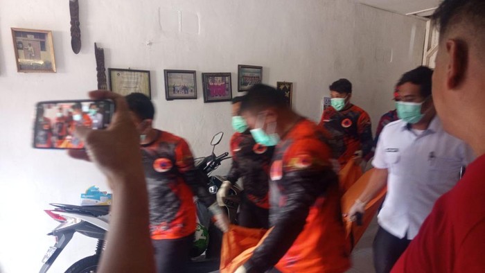 Petugas Inafis saat mengevakuasi jasad korban.