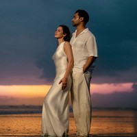 Pevita Pearce tampil serasi dengan suaminya, Mirzan Meer, saat menjalani pemotretan di pantai. Keduanya kompak kenakan busana simpel elegan dengan nuansa putih dan krem. Foto: Instagram/@pevpearce