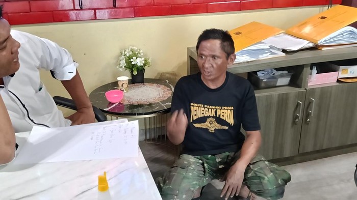 Tersangka Muhammad Ali saat diserahkan keluarga korban ke SPKT Polretabes Palembang