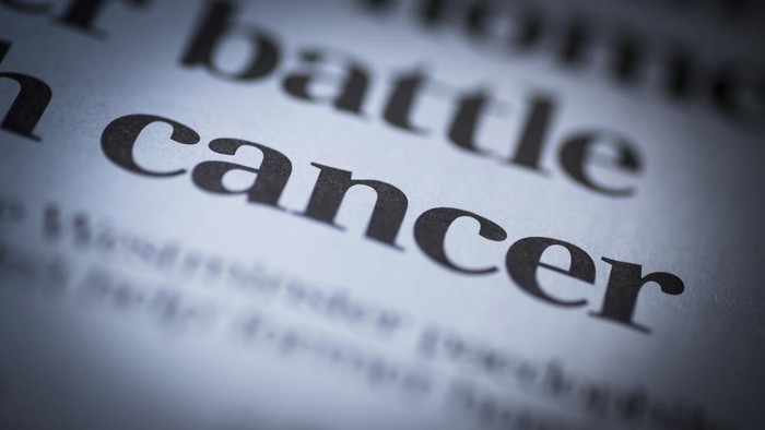 Cancer written newspaper, shallow dof, real newspaper.