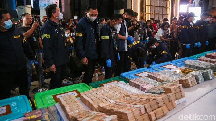 Tumpukan emas batangan dan uang asing bernilai fantastis menjadi pusat perhatian dalam konferensi pers yang digelar Polda Metro Jaya di Gedung Promoter, Jakarta, Jumat (10/7/2026). Barang bukti hasil penggeledahan di sejumlah lokasi itu dipamerkan di hadapan publik sebagai bagian dari penyidikan tiga perkara dugaan korupsi.