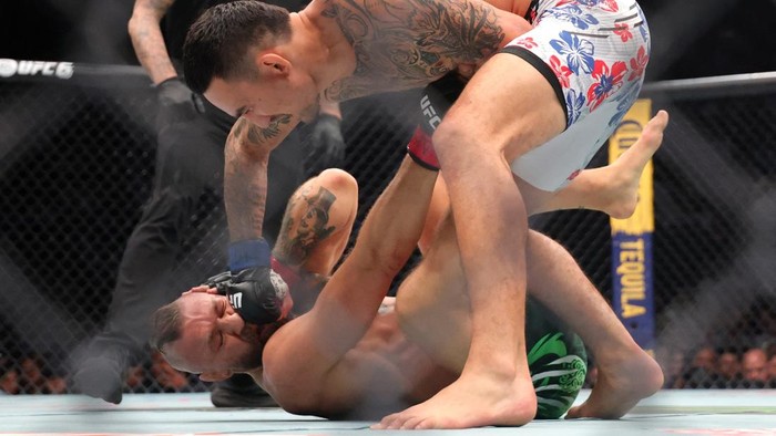 Jul 11, 2026; Las Vegas, Nevada, USA; Conor McGregor (red gloves) fights Max Holloway (blue gloves) in a welterweight bout during UFC 329 at T-Mobile Arena. Mandatory Credit: Mark J. Rebilas-Imagn Images