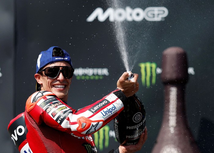FILE PHOTO: MotoGP - Czech Republic Grand Prix - Masaryk Circuit, Brno, Czech Republic - June 21, 2026 Ducati Lenovo Teams Marc Marquez sprays champagne out of the bottle after winning the race REUTERS/David W Cerny/File Photo