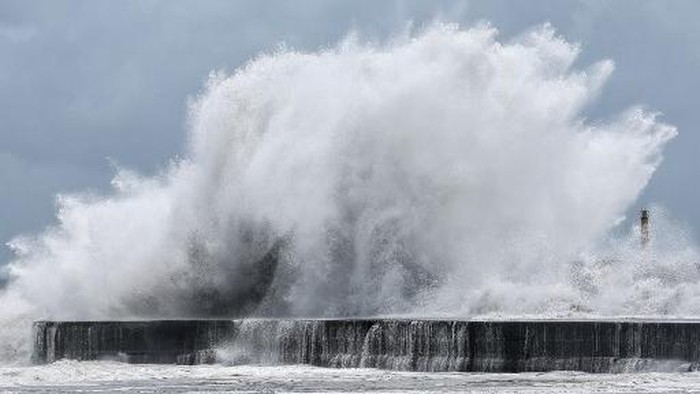 Strong waves break along the coast in Yilan on July 10, 2026, as Typhoon Bavi moves toward Northeastern Taiwan. (Photo by I-Hwa Cheng / AFP)