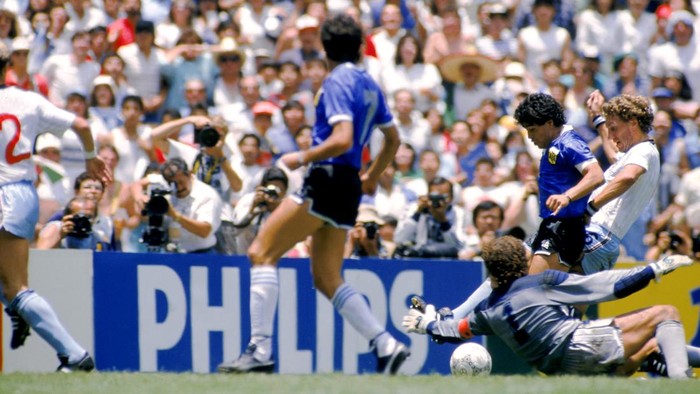 Argentinas Diego Maradona (second right) goes past Englands Terry Butcher (right) and Peter Shilton (on floor) to score his second goal of the game  (Photo by Peter Robinson/EMPICS via Getty Images)