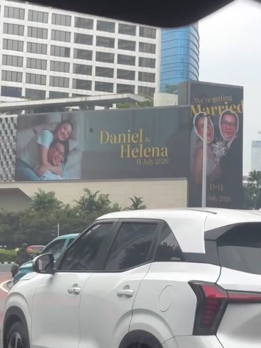 Tangkapan layar pengguna jalan saat merekam billboard ucapan pernikahan unik di kawasan Bundaran HI, Jakarta Pusat, yang mendadak viral di media sosial.