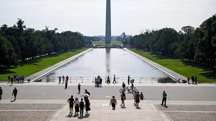 People gather near fencing surrounding the Lincoln Memorial Reflecting Pool on the National Mall in Washington, D.C., U.S., July 11, 2026. REUTERS/Daniel Heuer