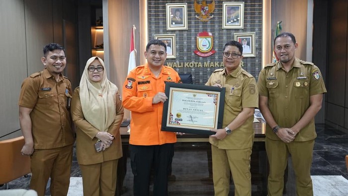 Wali Kota Makassar Munafri Arifuddin berfoto bersama jajaran Dinsos Makassar setelah meraih penghargaan dari Ombudsman RI.
