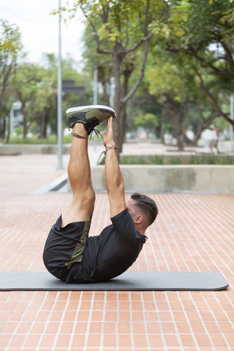 Young and attractive man doing fitness in outdoor park
