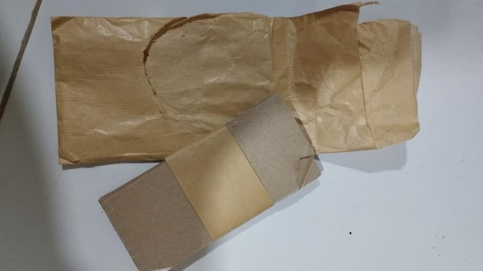 Barang bukti berupa uang tunai hasil penipuan pelaku, motor yang digunakan pelaku hingga amplop berisi kertas coklat dalam ukuran uang kertas.