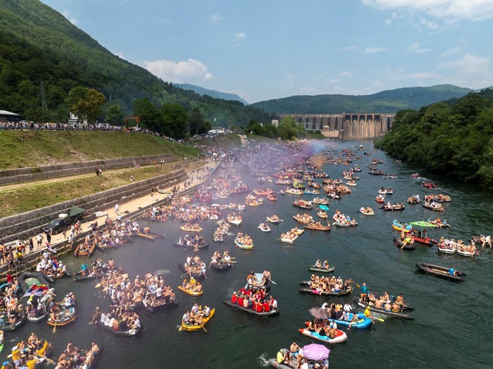 Drone view of people riding rafts and inflatable boats during the annual Drina Regatta on the Drina River near Bajina Basta, Serbia, July 18, 2026. The event, held for more than 30 years, attracts thousands of participants each year. REUTERS/Djordje Kojadinovic
