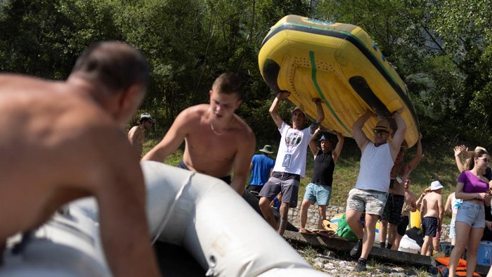 Drone view of people riding rafts and inflatable boats during the annual Drina Regatta on the Drina River near Bajina Basta, Serbia, July 18, 2026. The event, held for more than 30 years, attracts thousands of participants each year. REUTERS/Djordje Kojadinovic