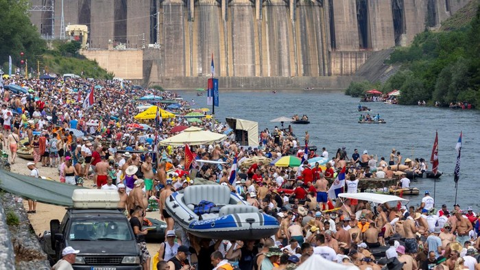 Drone view of people riding rafts and inflatable boats during the annual Drina Regatta on the Drina River near Bajina Basta, Serbia, July 18, 2026. The event, held for more than 30 years, attracts thousands of participants each year. REUTERS/Djordje Kojadinovic
