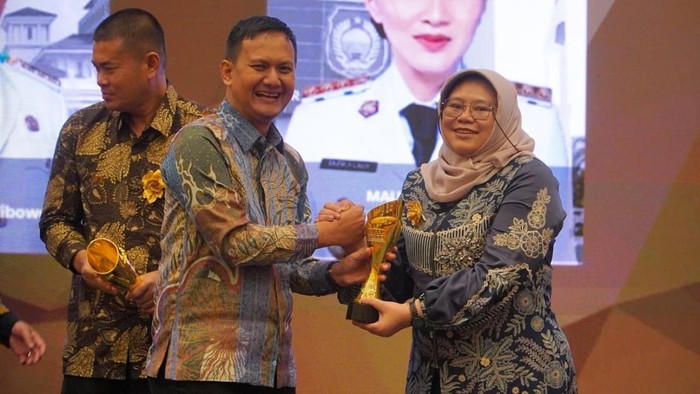 Kadis Kominfo Jatim Sherlita Ratna Dewi Agustin mewakili Gubernur Khofifah menerima penghargaan keterbukaan informasi.