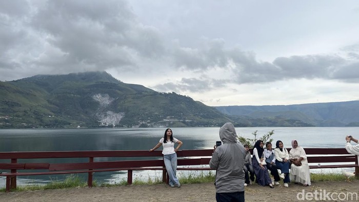 Pengunjung saat berfoto di objek wisata Tugu Raja Sitanggang, Samosir, Sumut.
