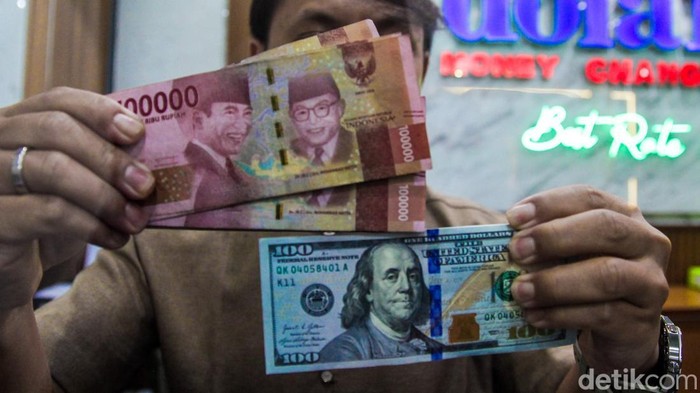 Petugas menata mata uang dolar AS dan rupiah di penukaran mata uang asing di Jakarta, Senin (20/7/2026).