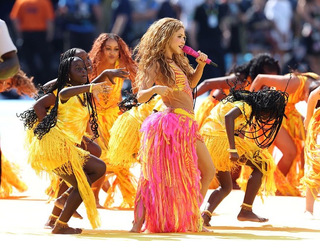 Aksen cut-out di sisi kanan dan kini gaun memperlihatkan siluet tubuhnya yang ramping dan seksi. Sementara itu, bagian rok dihias aksen rumbai pink-kuning yang menyatu hingga ke bawah. Foto: Getty Images for Global Citizen/Kevin Kane