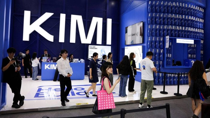 People walk past the Moonshot booth promoting its Kimi K3 AI model, during the World Artificial Intelligence Conference (WAIC) in Shanghai, China, July 17, 2026. REUTERS/Go Nakamura REFILE - ADDING INFORMATION