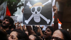 Bendera Jolly Roger, yang dulunya berkibar dengan bangga di atas kapal bajak laut Going Merry milik Luffy dan Bajak Laut Topi Jerami, secara bertahap menemukan tempatnya di luar dunia anime populer One Piece. Demonstrasi terjadi di Jadavpur, Kolkata, pada Senin malam (20/7) waktu setempat.  Foto: REUTERS/Francis Mascarenhas