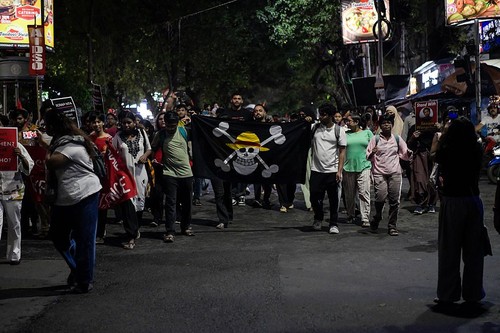 A supporter of the Cockroach Janta Party (CJP) holds a Straw Hat Pirates' Jolly Roger poster from the series One Piece after Sonam Wangchuk was moved by authorities to a hospital during his hunger strike, during a protest demanding the resignation of Indian Education Minister Dharmendra Pradhan, in Mumbai, India, July 19, 2026. REUTERS/Francis Mascarenhas
