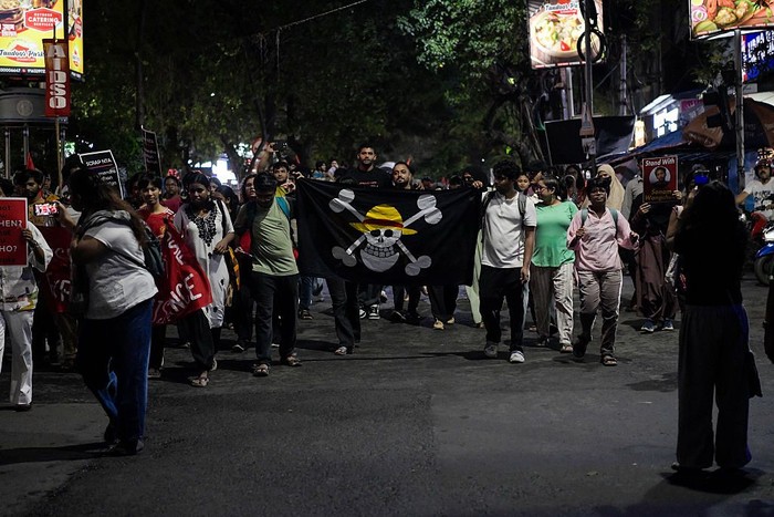 A supporter of the Cockroach Janta Party (CJP) holds a Straw Hat Pirates' Jolly Roger poster from the series One Piece after Sonam Wangchuk was moved by authorities to a hospital during his hunger strike, during a protest demanding the resignation of Indian Education Minister Dharmendra Pradhan, in Mumbai, India, July 19, 2026. REUTERS/Francis Mascarenhas