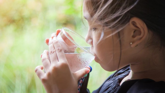 Asian women drink healthy water in the morning