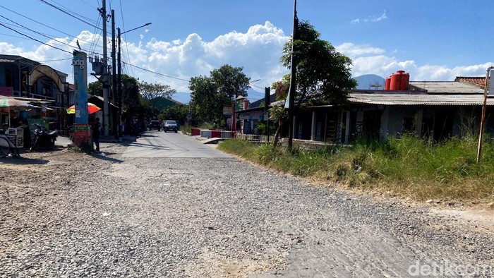 Jalan rusak di depan Stasiun Cimekar.