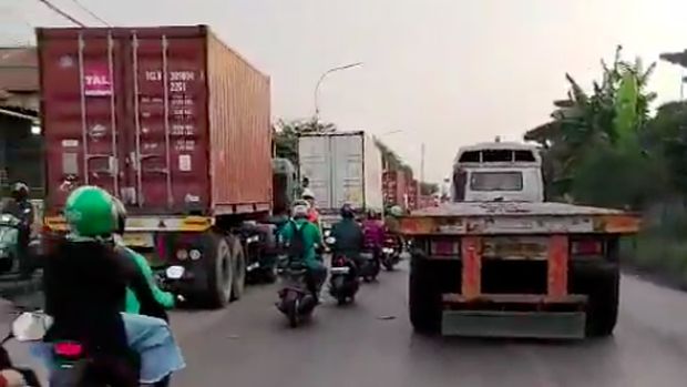 Lalu lintas di Jalan Cakung-Cilincing kembali padat hari ini. Kepadatan lalu lintas karena ada truk kontainer yang mengantre panjang di lajur kiri jalan. (dok TMC PMJ)