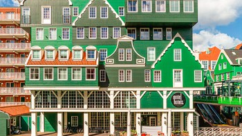 Hotel Inntel Hotel Zaandam di Belanda tampil mencolok dengan fasad yang menyerupai puluhan rumah tradisional Zaan yang ditumpuk menjadi satu bangunan. Desainnya menjadi salah satu contoh arsitektur modern yang bermain dengan ilusi visual. Foto: Weird Buildings via DesignBoom