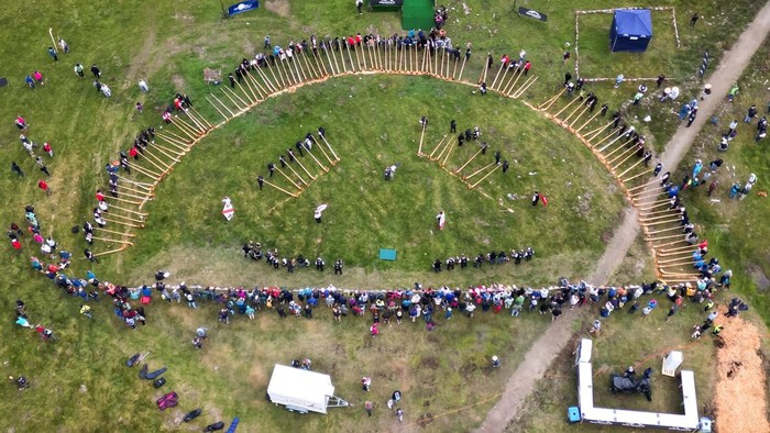 Alphorn blowers and flag throwers perform an ensemble piece on the last day of the International Alphorn Festival on the alpine pasture of Tracouet in Nendaz, in southern Switzerland, July 26, 2026. REUTERS/Pierre Albouy