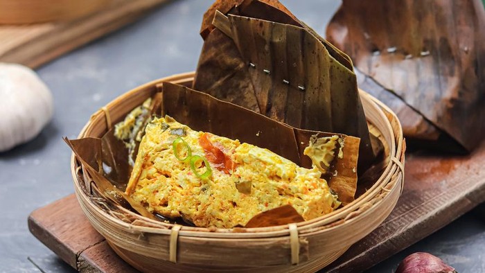 Pepes tahu udang kemangi, or Pepes Tofu Shrimp basil, is a traditional Indonesian dish made from shrimp and tofu crushed and seasoned with spices, then wrapped in banana leaves and steamed. Selective focus