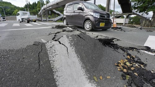 Vehicles pass a damaged road after an earthquake with a magnitude of 7.1 struck Japans southern Kumamoto prefecture, in Hikawa town, Kumamoto Prefecture, Japan, July 29, 2026. Kyodo/via REUTERS ATTENTION EDITORS - THIS IMAGE HAS BEEN SUPPLIED BY A THIRD PARTY. MANDATORY CREDIT. JAPAN OUT. NO COMMERCIAL OR EDITORIAL SALES IN JAPAN.