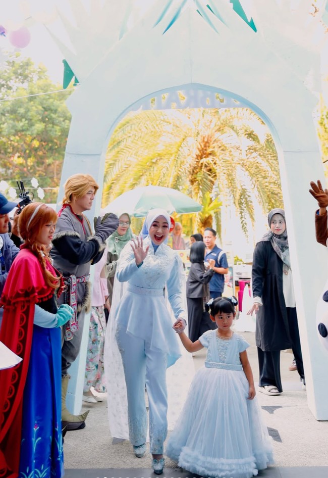 Sesuai dengan tema yang dipilih, Ricis dan putrinya kompak kenakan busana berwarna biru. Ricis tampil dengan atasan lengan panjang peplum dipadukan celana panjang senada. Ia juga melengkapi penampilannya dengan hijab polos berwarna biru muda. Foto: Instagram/@riaricis1795