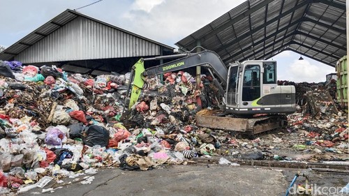 Ekskavator mengangkut tumpukan sampah di TPS Sempidi, Kecamatan Mengwi setelah didesak DLHK Badung agar tidak timbulkan bau, Selasa (28/7/2026).