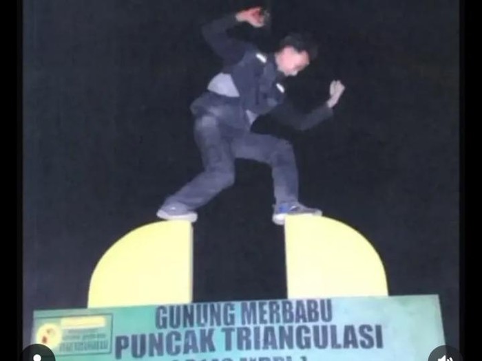 Penampakan seorang pendaki yang viral memanjat Tugu Puncak Triangulasi Gunung Merbabu. Foto diunggah Kamis (30/7/2026).