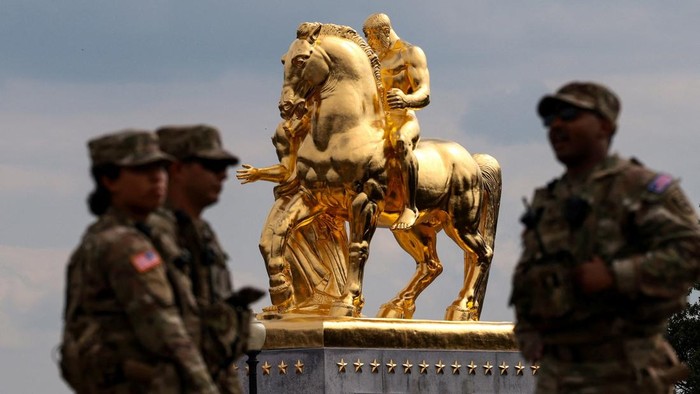 U.S. National Guard troops stand near the statues “Valor” and “Sacrifice”, the “Arts of War