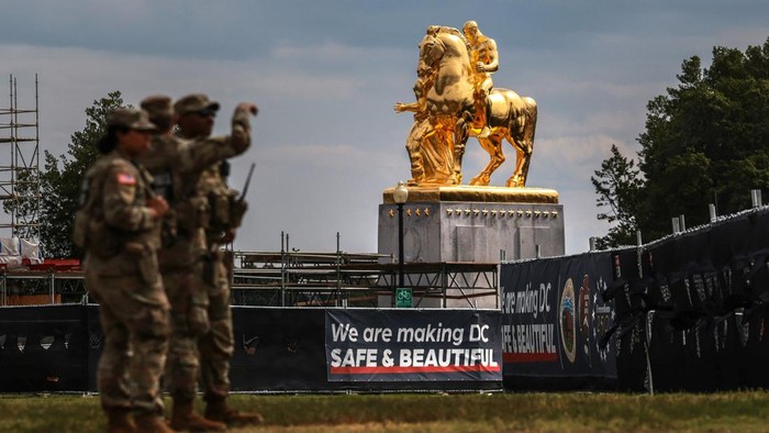 U.S. National Guard troops stand near the statues “Valor” and “Sacrifice”, the “Arts of War