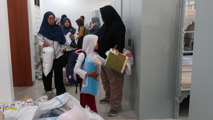 Petugas mengantarkan siswa menuju Asrama saat mulai menempati gedung baru di Sekolah Rakyat Terintegrasi 1 Banyuwangi, Muncar, Banyuwangi, Jawa Timur, Jumat (31/7/2026). Sebanyak 258 siswa yang terdiri atas 57 siswa jenjang SD, 111 siswa SMP dan 90 siswa SMA mulai menghuni gedung baru sekolah tersebut sekaligus mengikuti Masa Pengenalan Lingkungan Sekolah (MPLS) sebagai bagian dari persiapan kegiatan belajar mengajar tahun ajaran baru 2026/2027. ANTARA FOTO/Budi Candra Setya