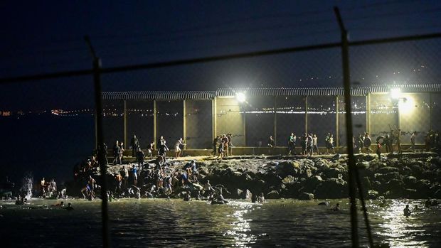Para migran ilegal dari Maroko nekat berenang untuk menyeberangi perbatasan Cuta, kota otonom Spanyo; di Afrika Utara Para migran ilegal dari Maroko nekat berenang untuk menyeberangi perbatasan Cuta, kota otonom Spanyo; di Afrika Utara
