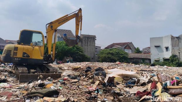 Damkar tetap menyemprotkan air ke tempat pembuangan sampah (TPS) liar di Kramat Jati, Jakarta Timur. Api terus disemprotkan agar api padam total. (Kurniawan/detikcom)