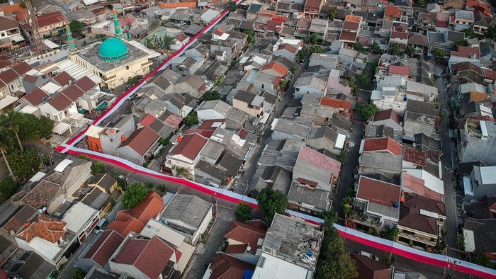 Foto udara bendera Merah Putih membentang menutupi jalan di Perumahan Puri Dewata Indah, Cipondoh, Kota Tangerang, Banten, Selasa (4/8/2026). Bendera Merah Putih sepanjang 400 meter dan lebar 1,5 meter yang menghiasi jalan perumahan tersebut dibuat secara gotong royong oleh warga setempat dengan biaya swadaya sekitar Rp25 juta untuk menyambut HUT ke-81 Kemerdekaan RI. ANTARA FOTO/Putra M. Akbar