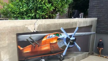Anamorphic Airplane karya Jan Is De Man di IJsselstein, Belanda, memanfaatkan dinding miring di dekat parkir bawah tanah hingga pesawat tampak lepas landas dari landasan. Ilusi hanya terlihat sempurna dari sudut pandang tertentu. Foto: via StreetArtUtopia