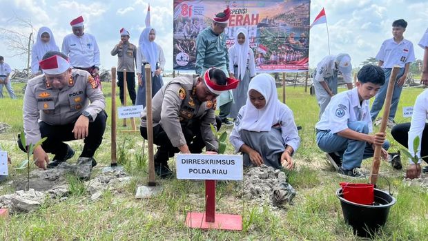 Tim Ekspedisi Merah Putih Presisi Polda Riau menyerahkan bantuan sosial, mensin ketinting hingga menanam mangrove di Pantai Otis, Teluk Meranti, Pelalawan, Selasa (4/8/2026).